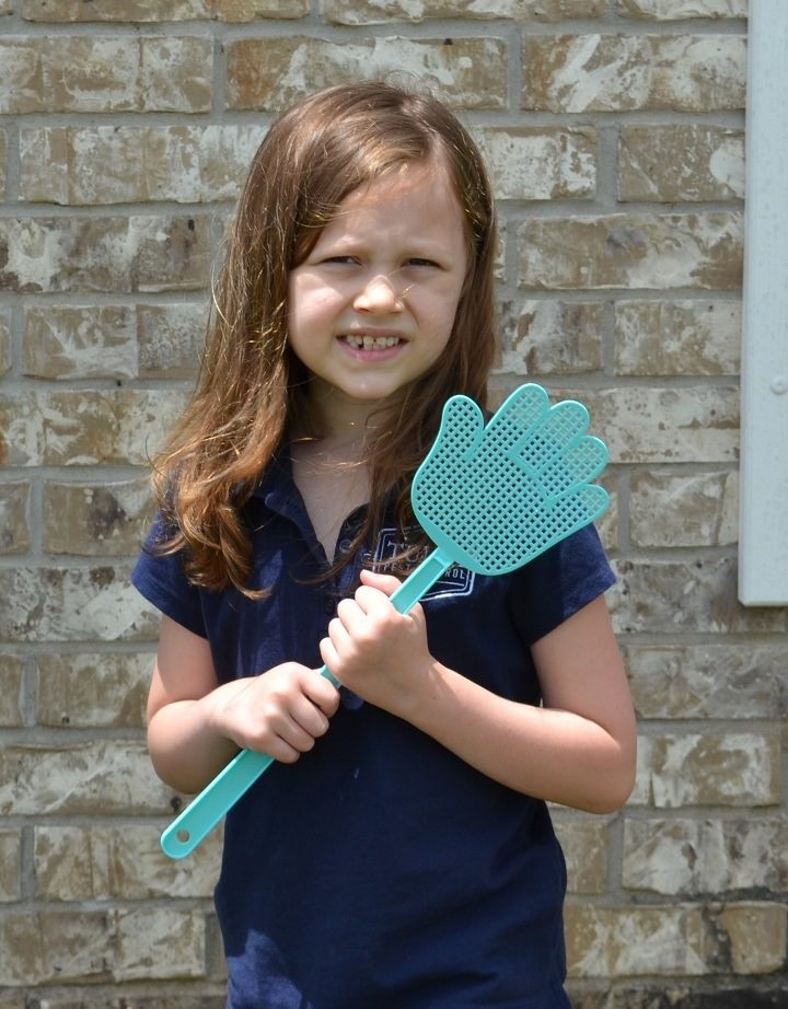 Little girl with fly swatter.
